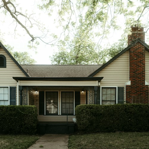 Completed siding replacement, brick and clapboard exterior