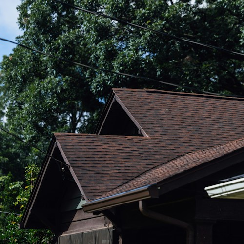 Post-storm inspection, hail-damaged brown shingles