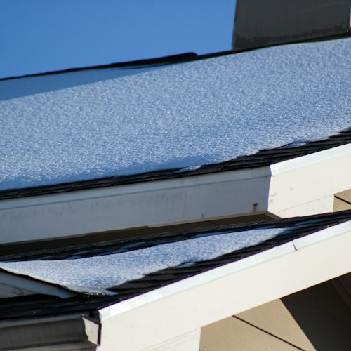 Roof replacement completed, dark shingles on residential home
