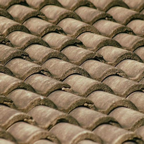 Completed tile roof replacement, terracotta tiles on suburban home