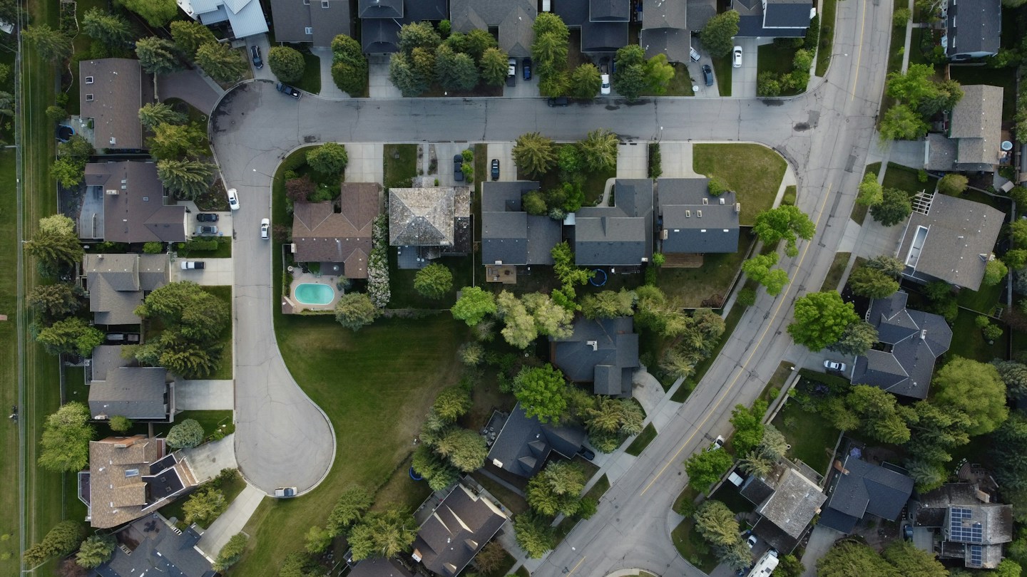 Aerial view of a residential neighborhood served by Slope Masters Roofing in Plano, TX